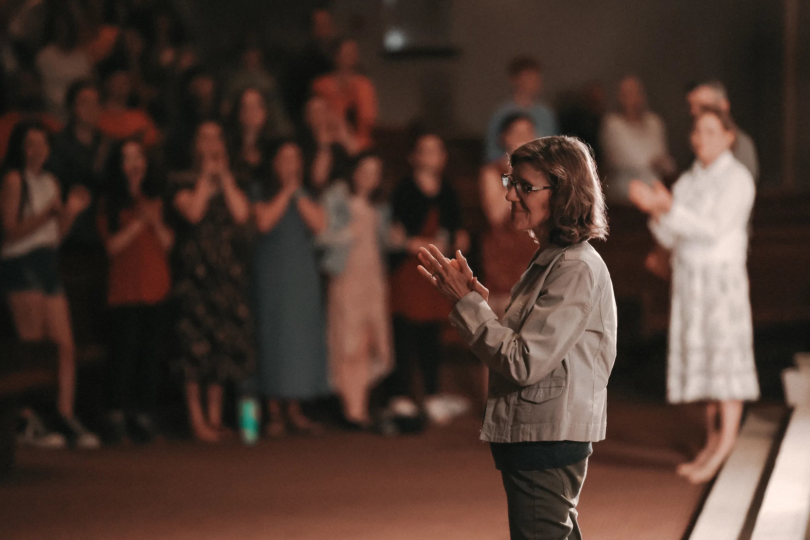 The congregation on its feet, applauding during a Sunday service