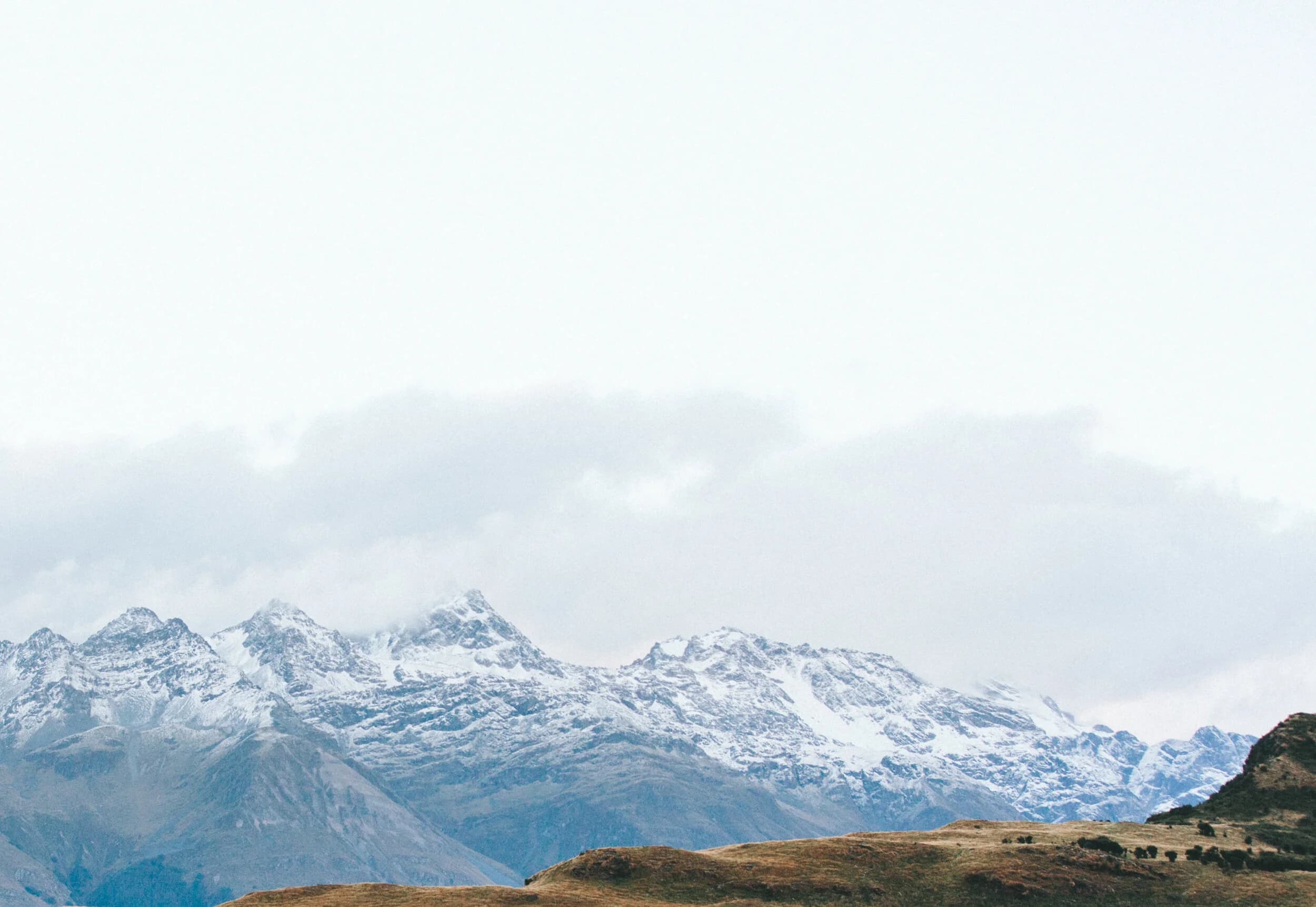 Snow-capped mountains under a wide open sky