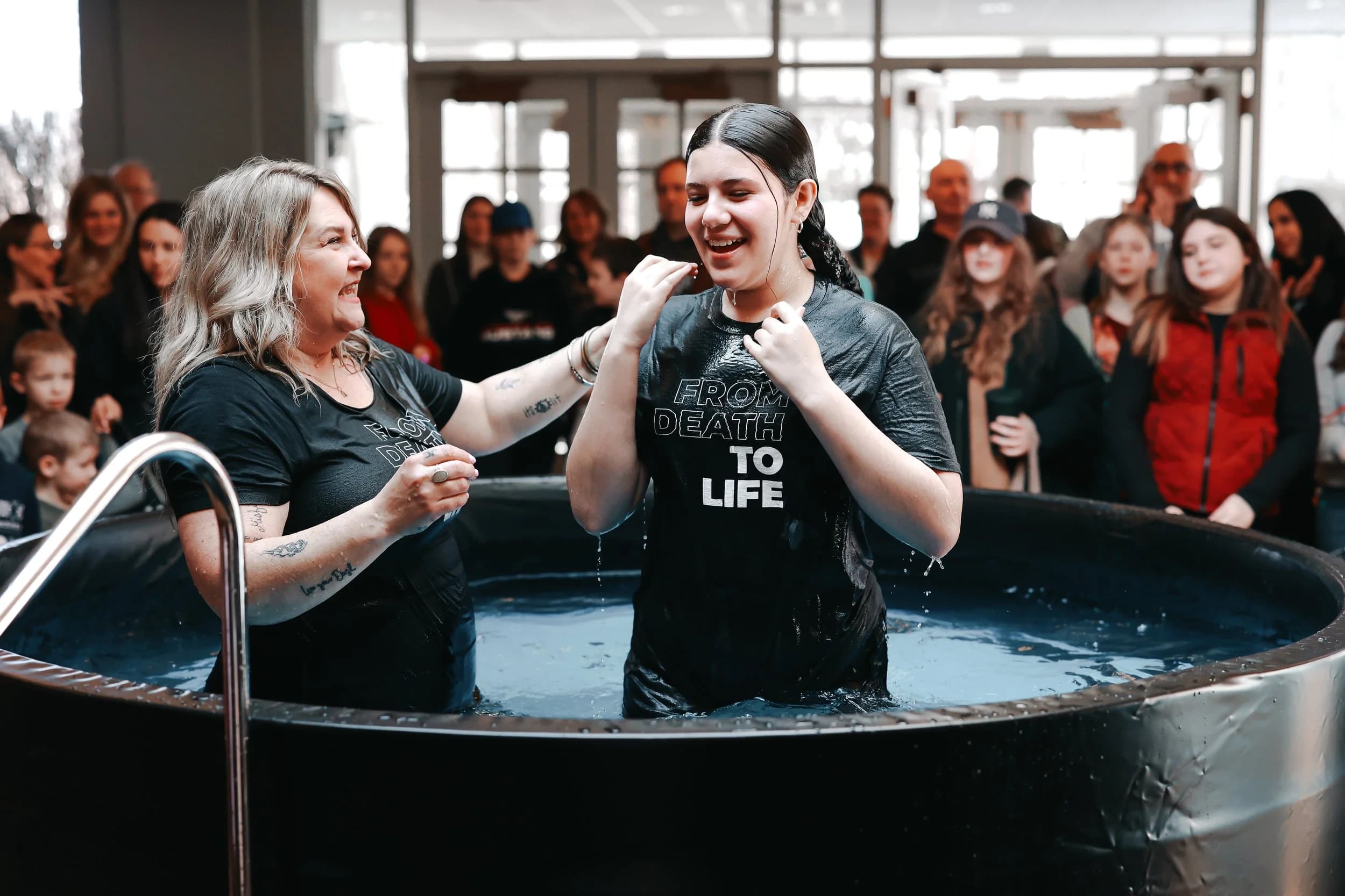 Annie Bullard celebrating a baptism surrounded by the congregation