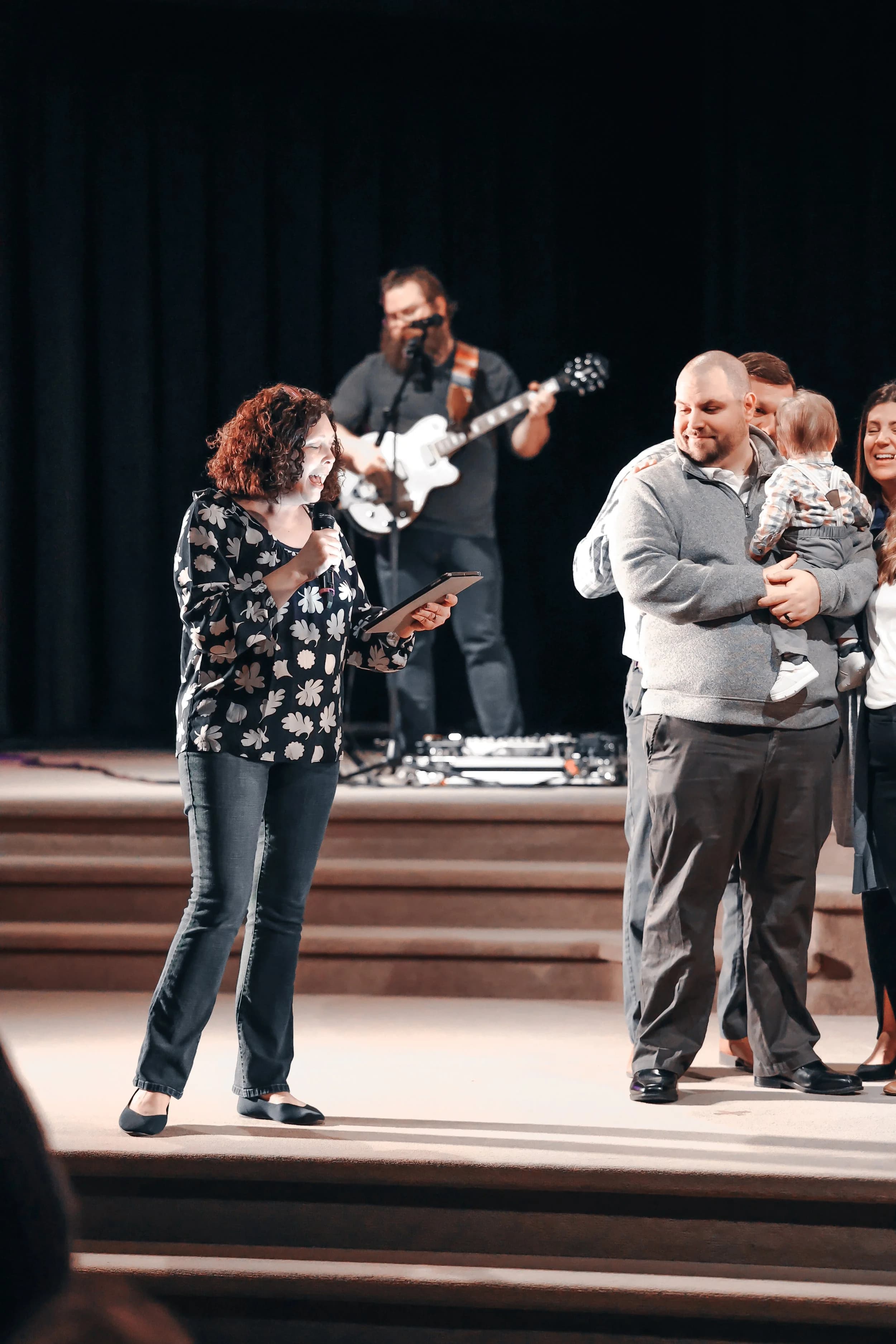 Lisa Durant speaking on stage during a church service