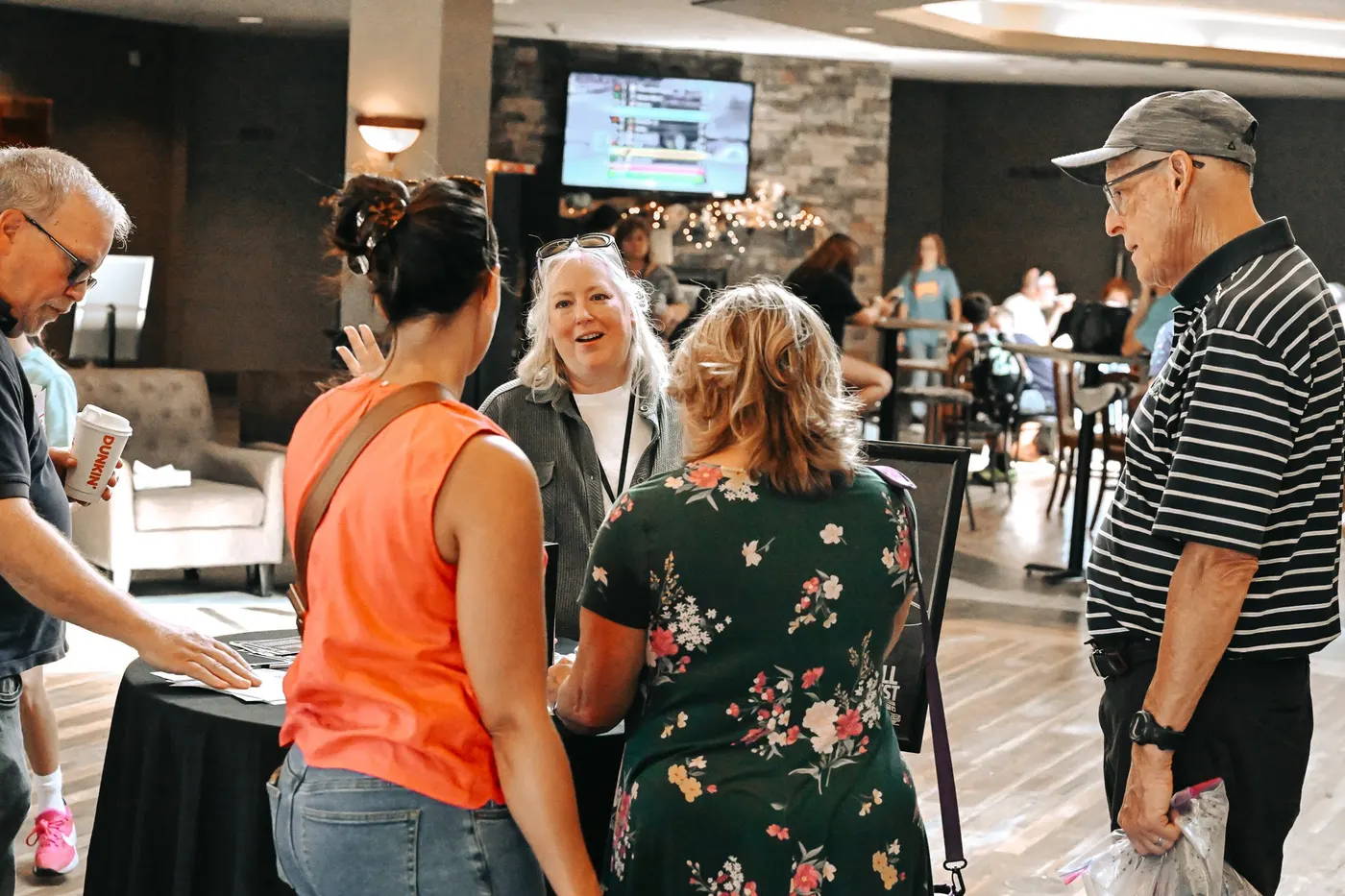 Friends catching up around a table in the lobby
